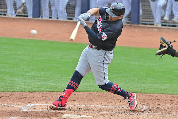 Feb 26, 2024; Peoria, Arizona, USA; Cleveland Guardians first baseman Josh Naylor (22) singles in the third inning against the San Diego Padres during a spring training game at Peoria Sports Complex.